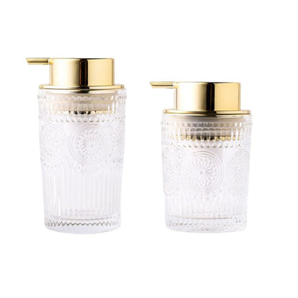 Dispenser sapone in vetro dosatore dorato.