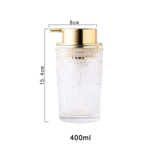 Dispenser sapone in vetro dosatore dorato.